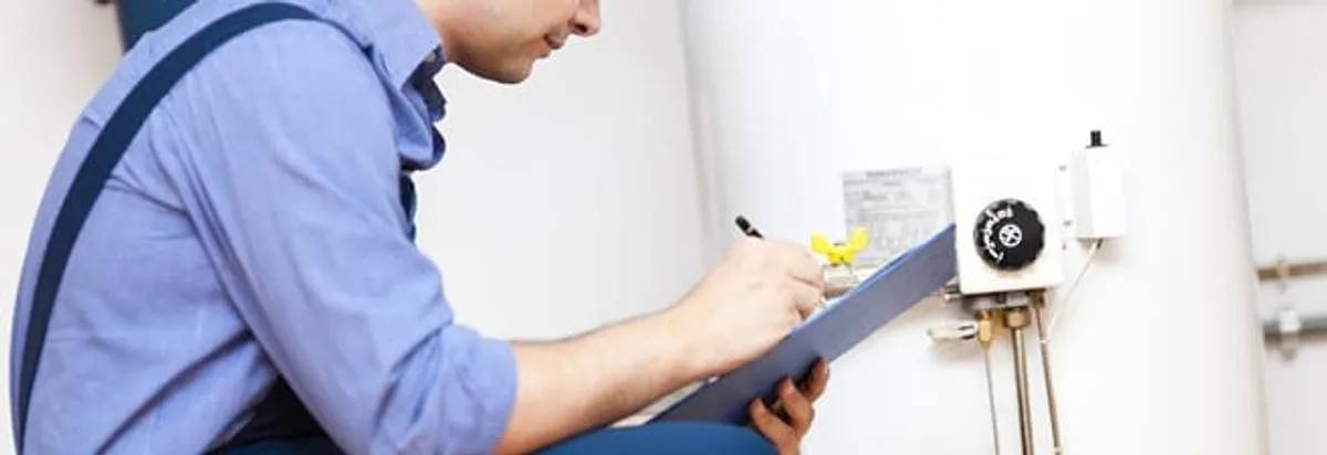 Water heater repair technician inspecting the unit and recording service notes in San Jose, CA
